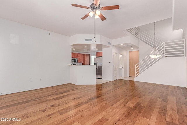 16 W Encanto Blvd Unit 26, Phoenix, AZ 85003 - unfurnished living room with stairway, a ceiling fan, light wood-style floors, baseboards, and recessed lighting