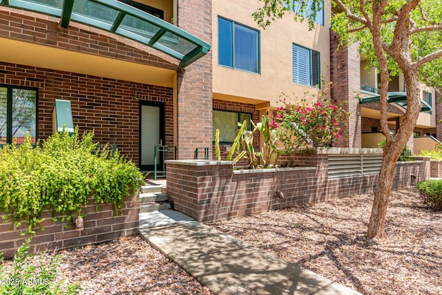 16 W Encanto Blvd Unit 26, Phoenix, AZ 85003 - doorway to property featuring brick siding and stucco siding