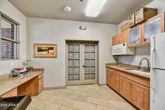 16 W Encanto Blvd Unit 26, Phoenix, AZ 85003 - kitchen featuring white appliances, a sink, baseboards, a textured ceiling, and light tile patterned floors
