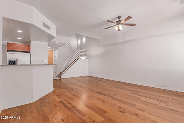 16 W Encanto Blvd Unit 26, Phoenix, AZ 85003 - unfurnished living room with ceiling fan, light wood-style floors, stairs, baseboards, and recessed lighting