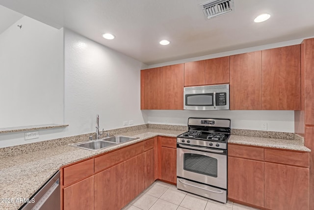 16 W Encanto Blvd Unit 26, Phoenix, AZ 85003 - kitchen featuring stainless steel appliances, a sink, recessed lighting, light tile patterned floors, and light stone countertops