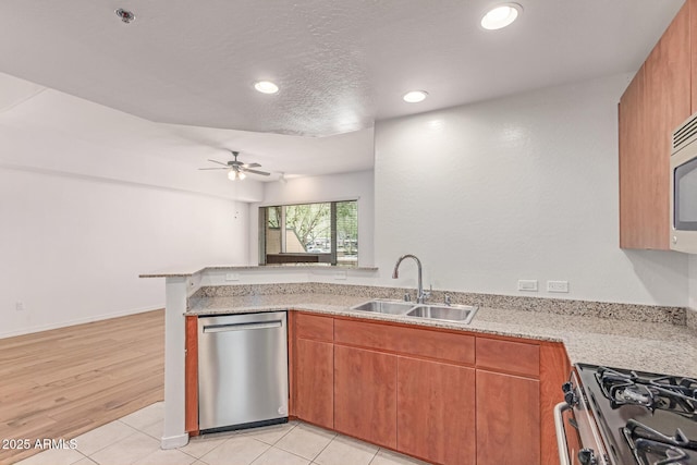 16 W Encanto Blvd Unit 26, Phoenix, AZ 85003 - kitchen with dishwasher, a sink, ceiling fan, gas range, and a peninsula