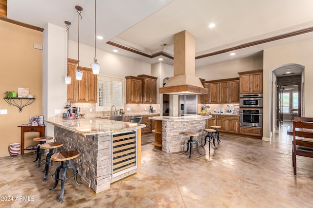 kitchen with decorative backsplash, light stone countertops, a center island, and a breakfast bar