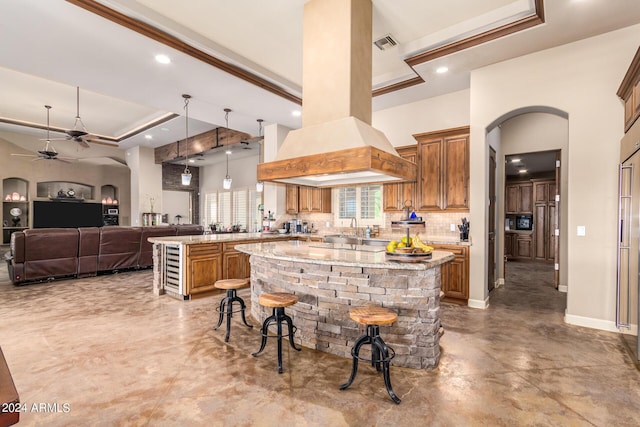 kitchen with a center island, a kitchen breakfast bar, kitchen peninsula, and custom exhaust hood