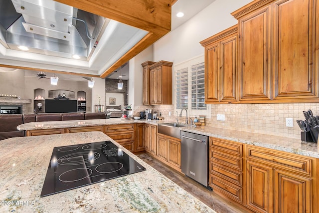 kitchen with black electric cooktop, sink, stainless steel dishwasher, and light stone countertops