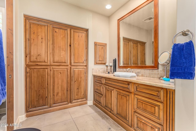 bathroom featuring vanity, tile patterned floors, and decorative backsplash