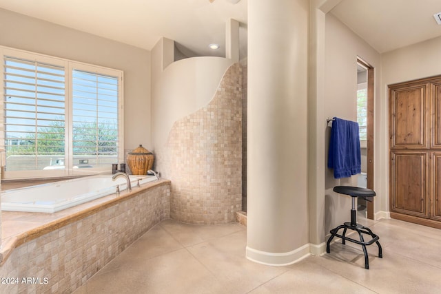 bathroom with a relaxing tiled tub