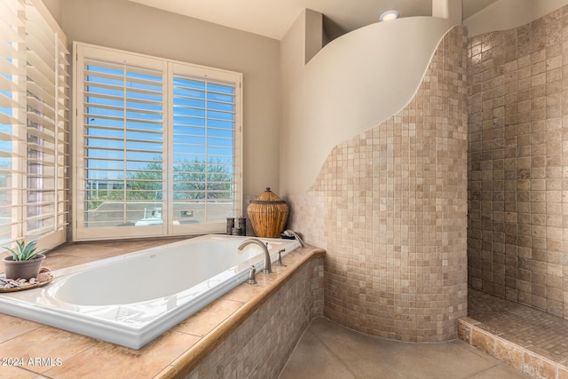 bathroom featuring a relaxing tiled tub