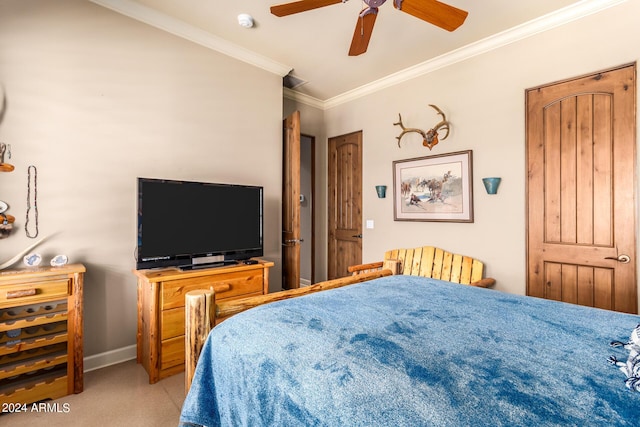 carpeted bedroom featuring crown molding and ceiling fan