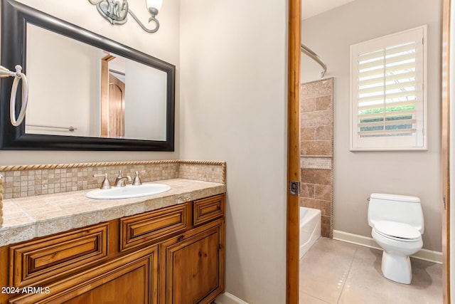 full bathroom with tile patterned floors, toilet, shower / bathing tub combination, vanity, and backsplash