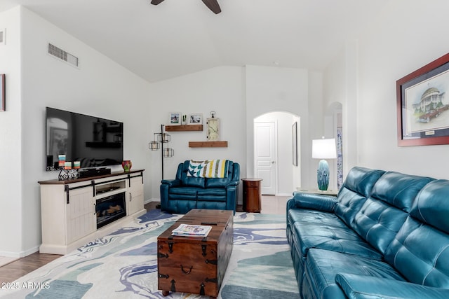 1341 E Bellerive Dr, Chandler, AZ 85249 - living room featuring arched walkways, ceiling fan, vaulted ceiling, wood finished floors, and a fireplace