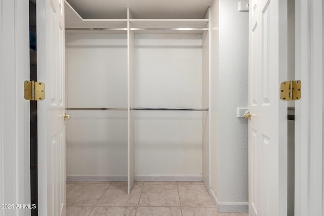 spacious closet featuring tile patterned flooring