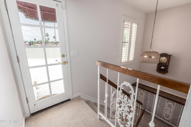doorway with carpet and baseboards