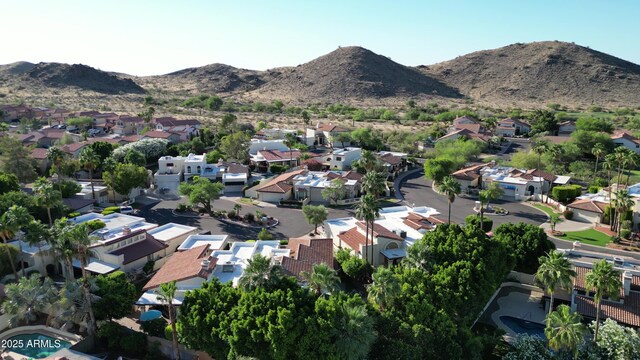 aerial overview of property's location featuring nearby suburban area and a mountain backdrop