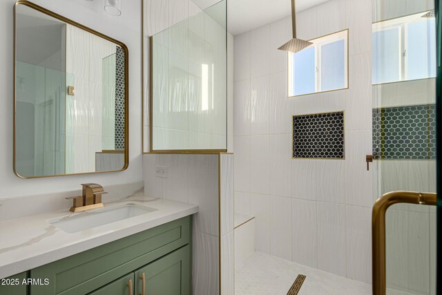 bathroom featuring vanity and a shower with door