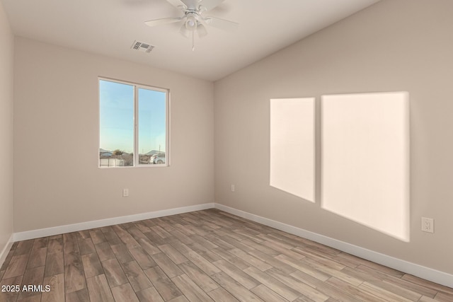 empty room featuring light wood-type flooring, ceiling fan, and lofted ceiling