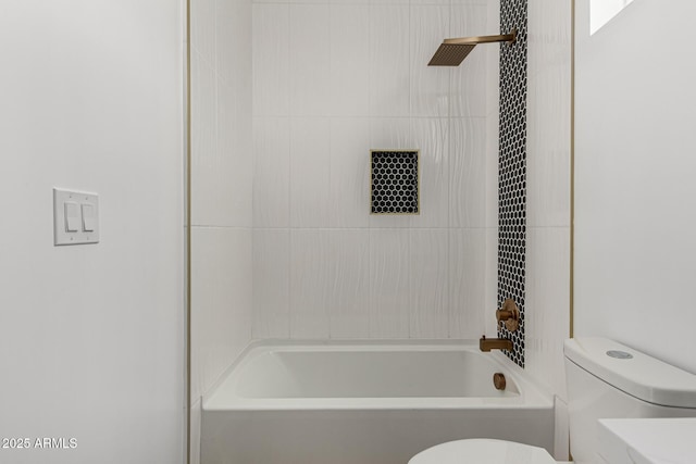 bathroom featuring toilet and tiled shower / bath combo