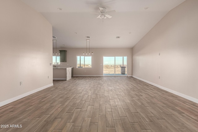 unfurnished living room with ceiling fan and lofted ceiling