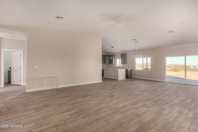 unfurnished living room featuring ceiling fan