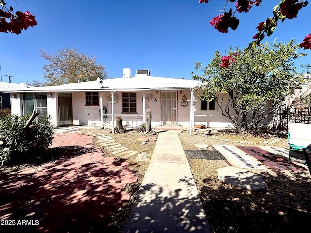 view of front facade featuring fence and stucco siding