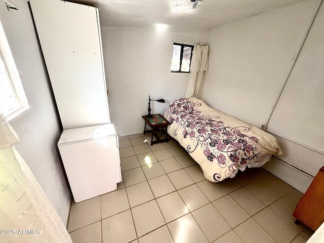 bedroom featuring light tile patterned floors