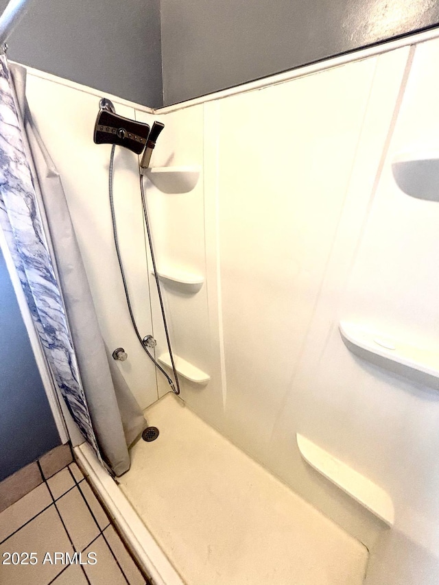 full bath with a shower stall and tile patterned floors