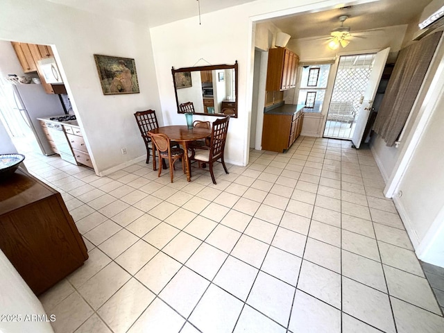 dining room with light tile patterned floors, ceiling fan, and baseboards