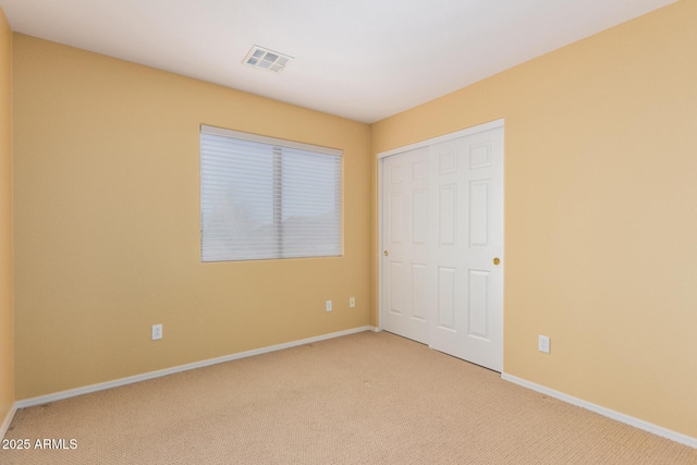 2526 W Florentine Rd, Phoenix, AZ 85086 - unfurnished bedroom with light carpet, baseboards, and a closet