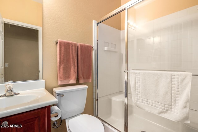 2526 W Florentine Rd, Phoenix, AZ 85086 - bathroom with vanity, a textured wall, a shower stall, and toilet