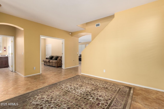 2526 W Florentine Rd, Phoenix, AZ 85086 - spare room with arched walkways, tile patterned floors, and baseboards
