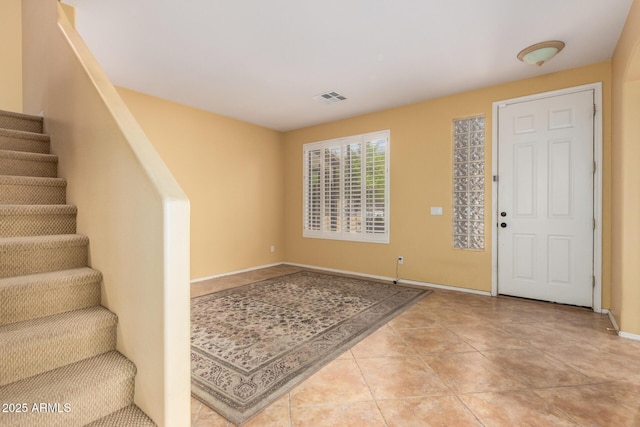 2526 W Florentine Rd, Phoenix, AZ 85086 - entryway featuring stairs, light tile patterned flooring, and baseboards