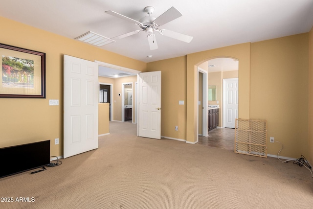 2526 W Florentine Rd, Phoenix, AZ 85086 - unfurnished bedroom with arched walkways, carpet floors, baseboards, and a ceiling fan