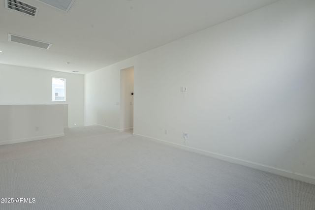 spare room featuring light colored carpet