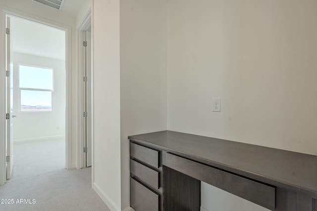 hallway with light colored carpet