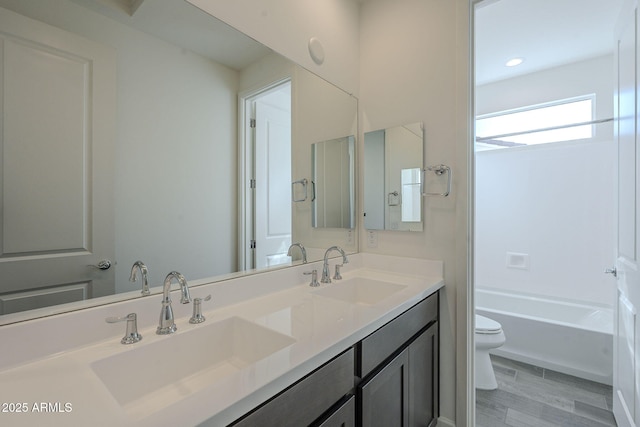 bathroom with vanity, hardwood / wood-style floors, and toilet