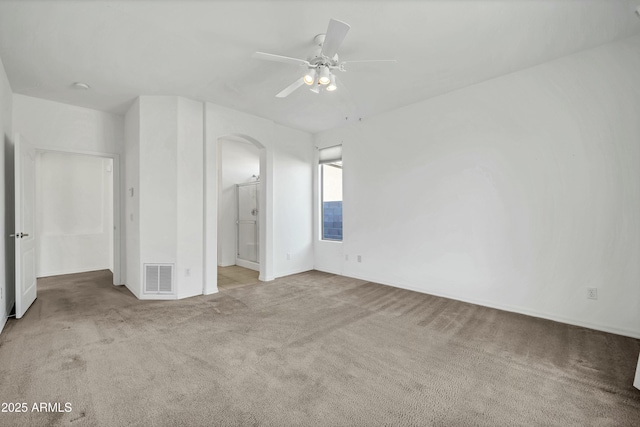 empty room featuring ceiling fan and light carpet