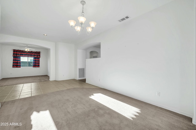 spare room with light carpet and ceiling fan with notable chandelier