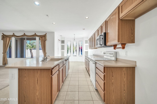 kitchen featuring pendant lighting, sink, an island with sink, light tile patterned flooring, and stainless steel appliances