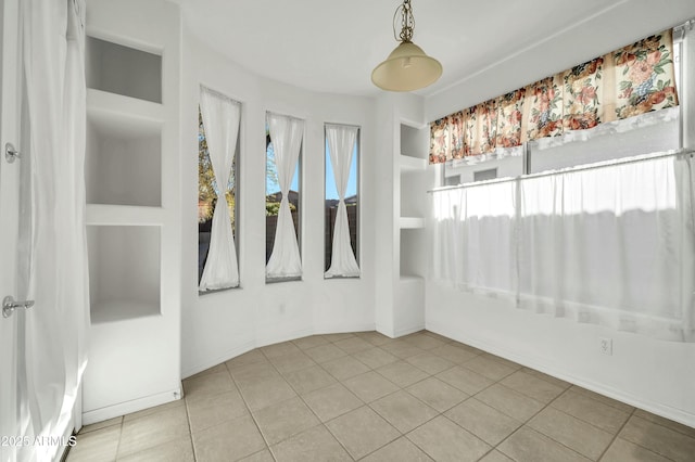 unfurnished room featuring tile patterned flooring