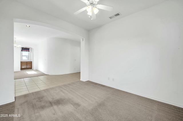 unfurnished room featuring ceiling fan and light colored carpet