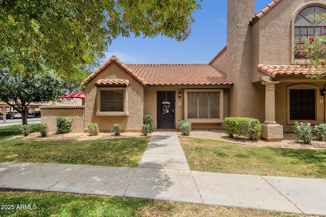 3491 N Arizona Ave Unit 118, Chandler, AZ 85225 - view of front facade featuring a tiled roof, stucco siding, and a front lawn