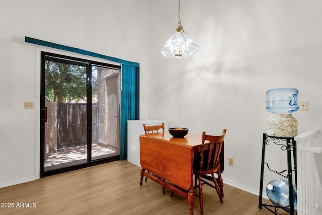 3491 N Arizona Ave Unit 118, Chandler, AZ 85225 - dining area featuring light wood finished floors and baseboards