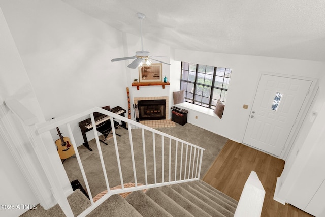 3491 N Arizona Ave Unit 118, Chandler, AZ 85225 - foyer with a fireplace, wood finished floors, stairs, ceiling fan, and a textured ceiling