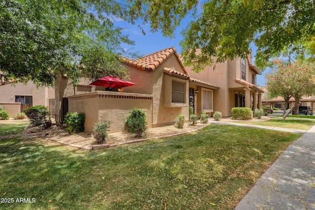 3491 N Arizona Ave Unit 118, Chandler, AZ 85225 - mediterranean / spanish-style home featuring a tiled roof, stucco siding, and a front yard