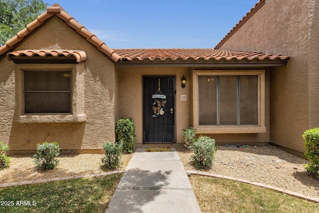 3491 N Arizona Ave Unit 118, Chandler, AZ 85225 - doorway to property with a tile roof and stucco siding