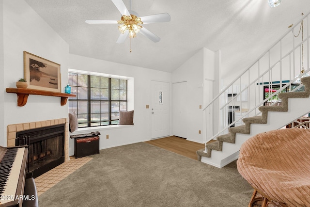 3491 N Arizona Ave Unit 118, Chandler, AZ 85225 - carpeted entrance foyer featuring stairs, a tile fireplace, a ceiling fan, lofted ceiling, and baseboards