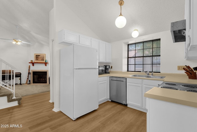 3491 N Arizona Ave Unit 118, Chandler, AZ 85225 - kitchen featuring freestanding refrigerator, stainless steel dishwasher, vaulted ceiling, a sink, and light wood-style flooring