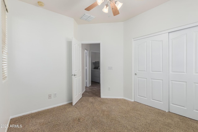 unfurnished bedroom featuring visible vents, baseboards, a closet, independent washer and dryer, and carpet