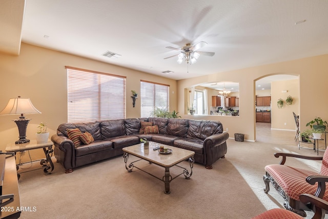 carpeted living room featuring ceiling fan