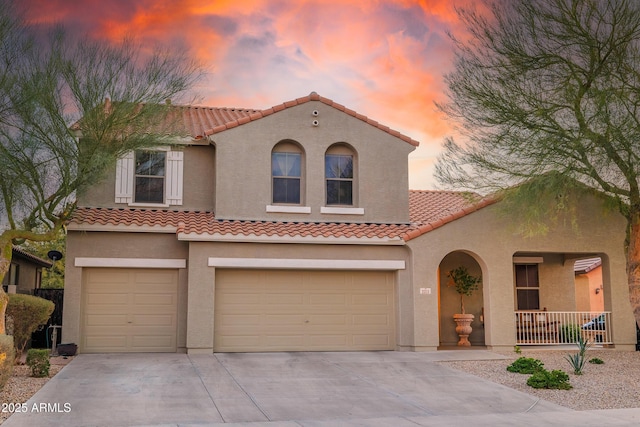 mediterranean / spanish house with a garage